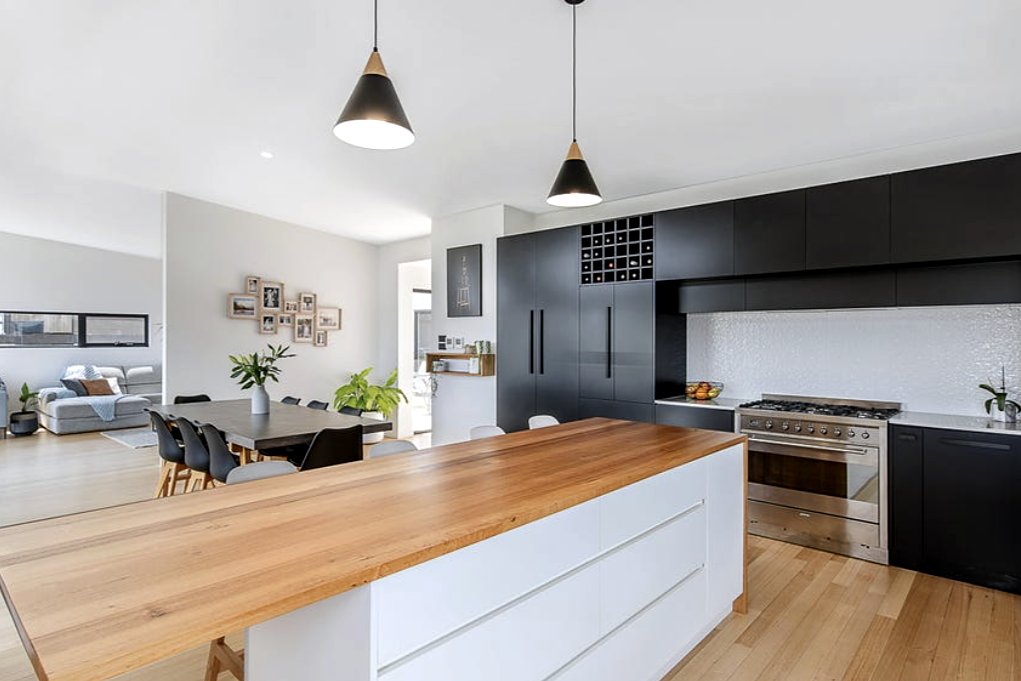 Fort Direction kitchen with timber-topped island, black joinery and pendant lights, built by LHPL Contracting