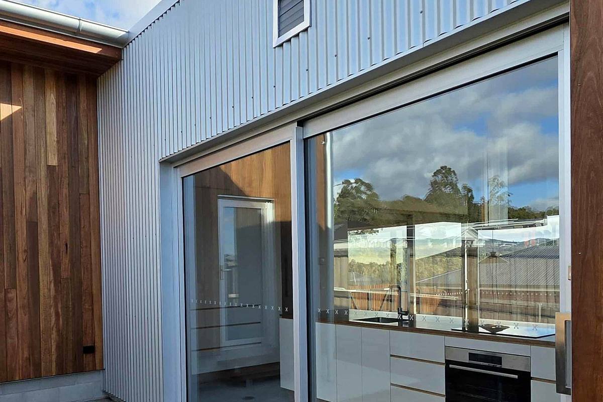 Kingston new residence, courtyard with timber cladding and sliding doors, built by LHPL Contracting
