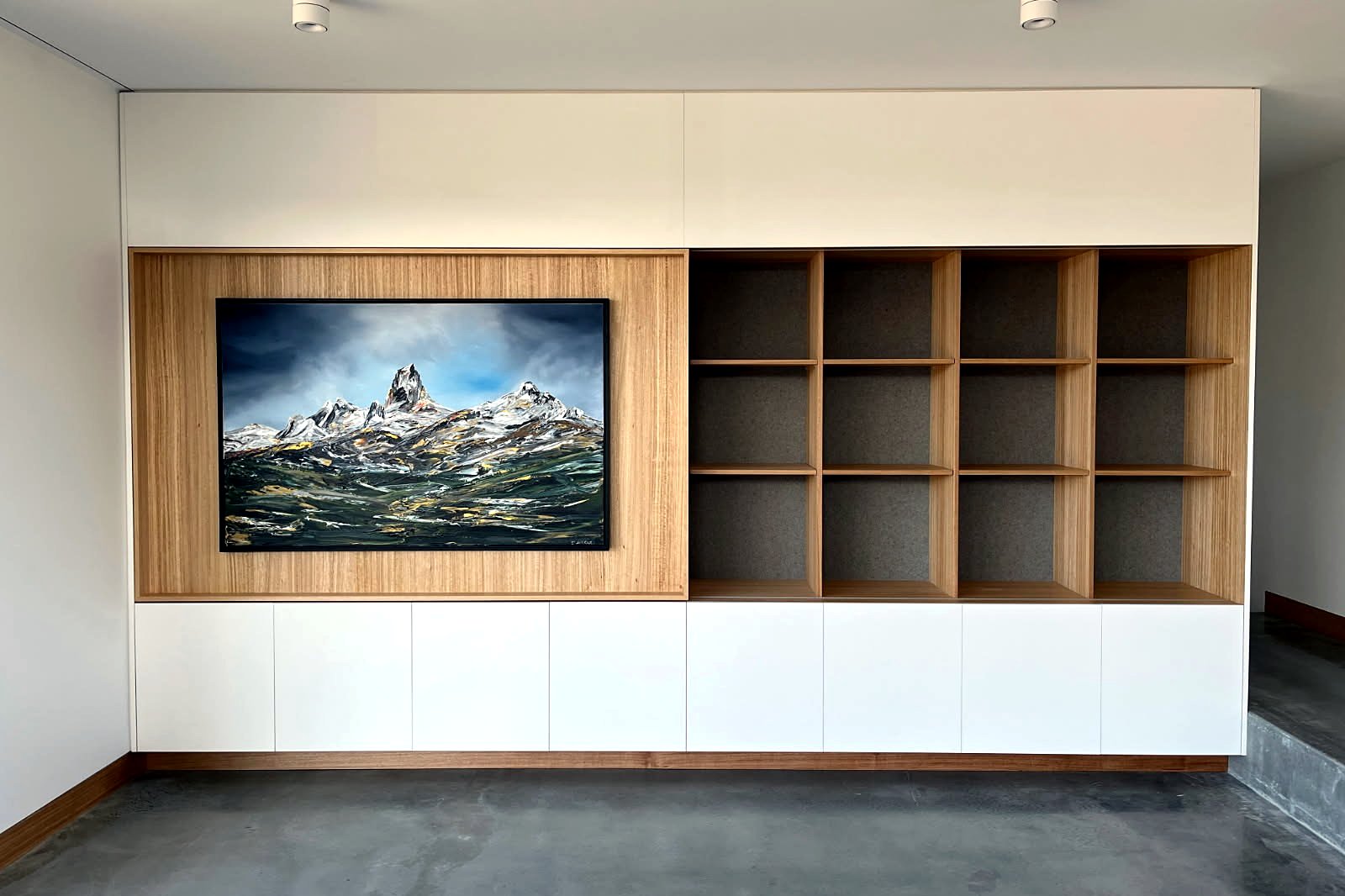 Kingston living room joinery wall in timber and white two-pack over burnished concrete floor, built by LHPL Contracting