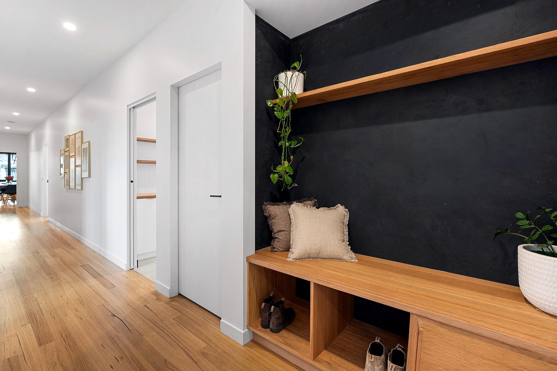 Pardalote ensuite with twin timber vanities, round mirrors and freestanding bath