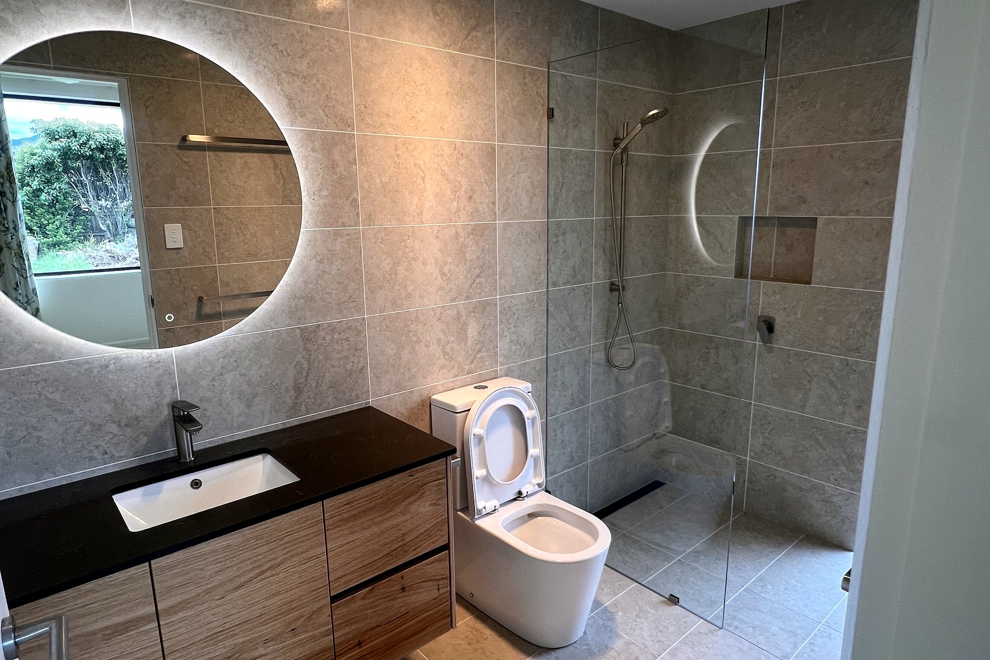 Richmond bathroom with backlit mirror, timber vanity and walk-in shower