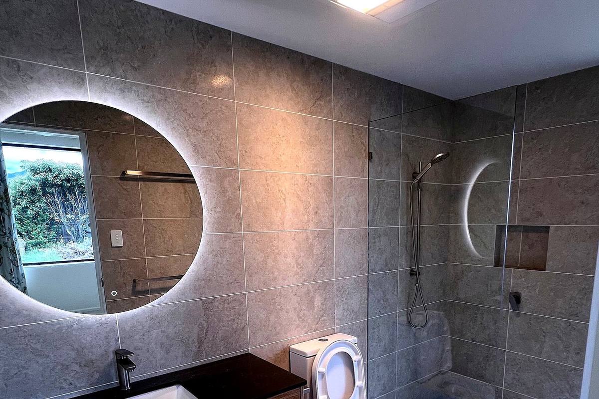 Richmond alterations and additions, bathroom with backlit mirror and walk-in shower, 1+2 Architecture, built by LHPL Contracting